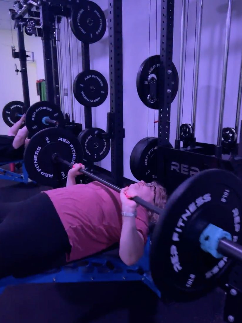 Member bench pressing at Thrive’s Lincoln Street strength studio